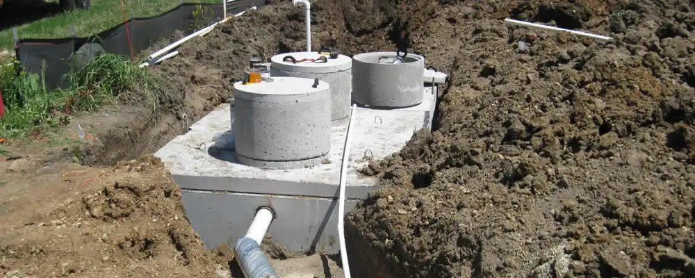 Septic system repair and installation site with tank access ports in Des Moines, IA