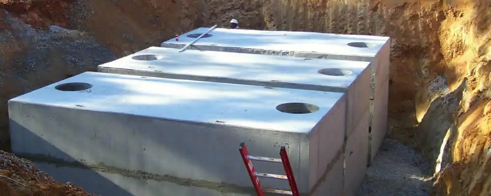Septic tank installation site with a newly placed concrete tank in Des Moines, IA
